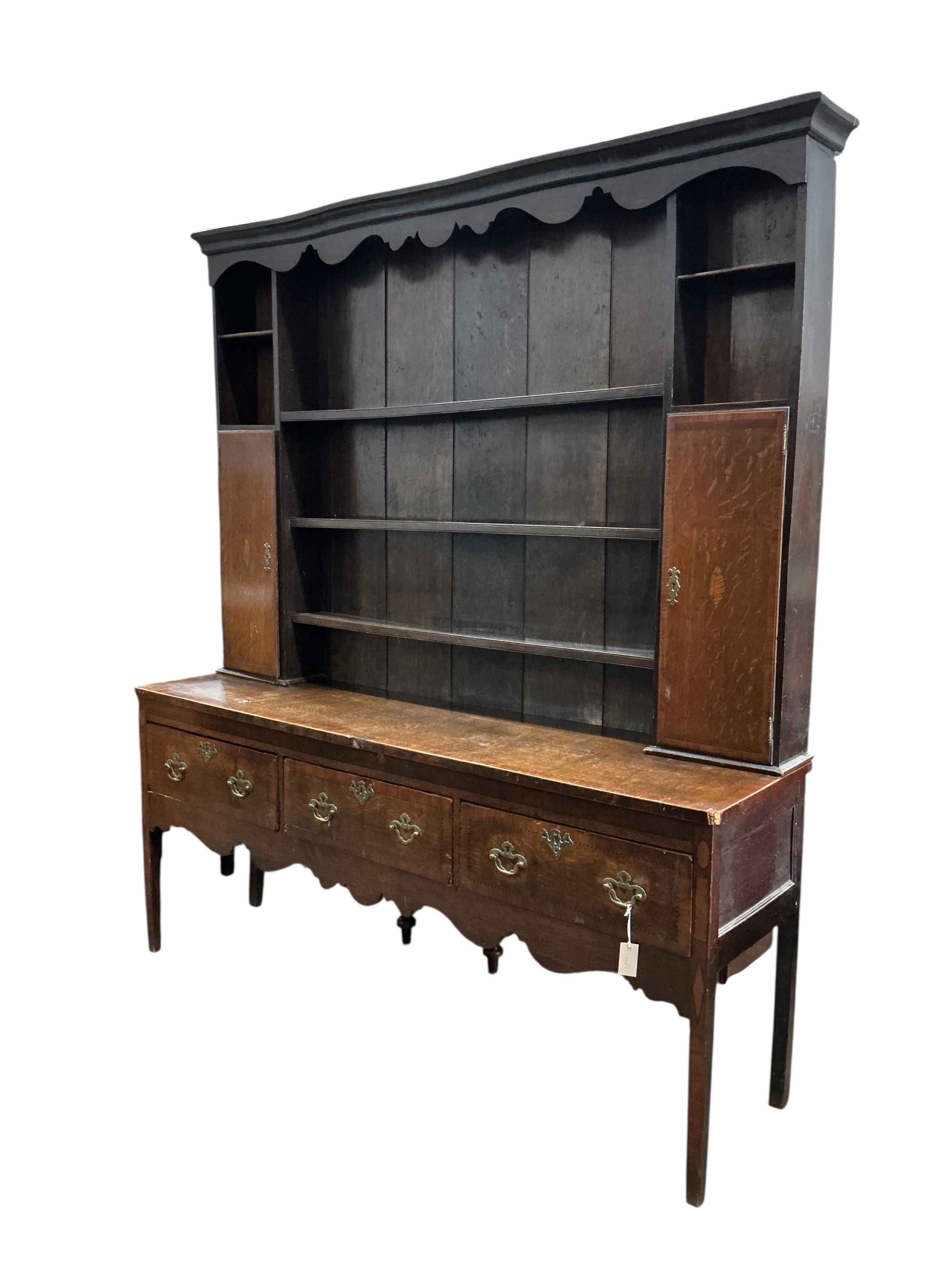 A George III banded mahogany dresser with boarded rack, width 185cm, depth 48cm, height 212cm